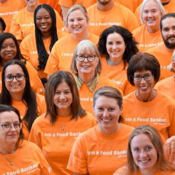 group of people wearing orange shirts