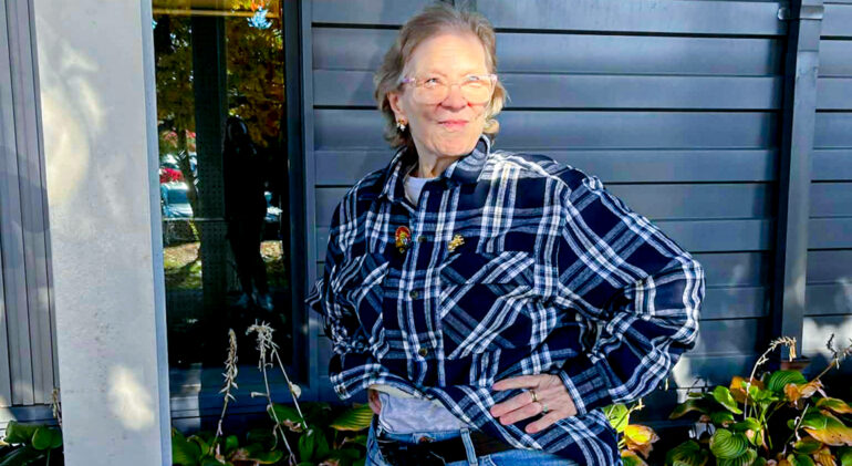white woman wearing plaid button down smiling